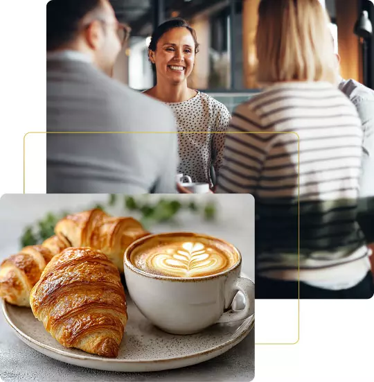 Colazione. Due persone conversano al tavolo mentre una terza sorseggia un cappuccino con un croissant a lato, creando un'atmosfera accogliente.